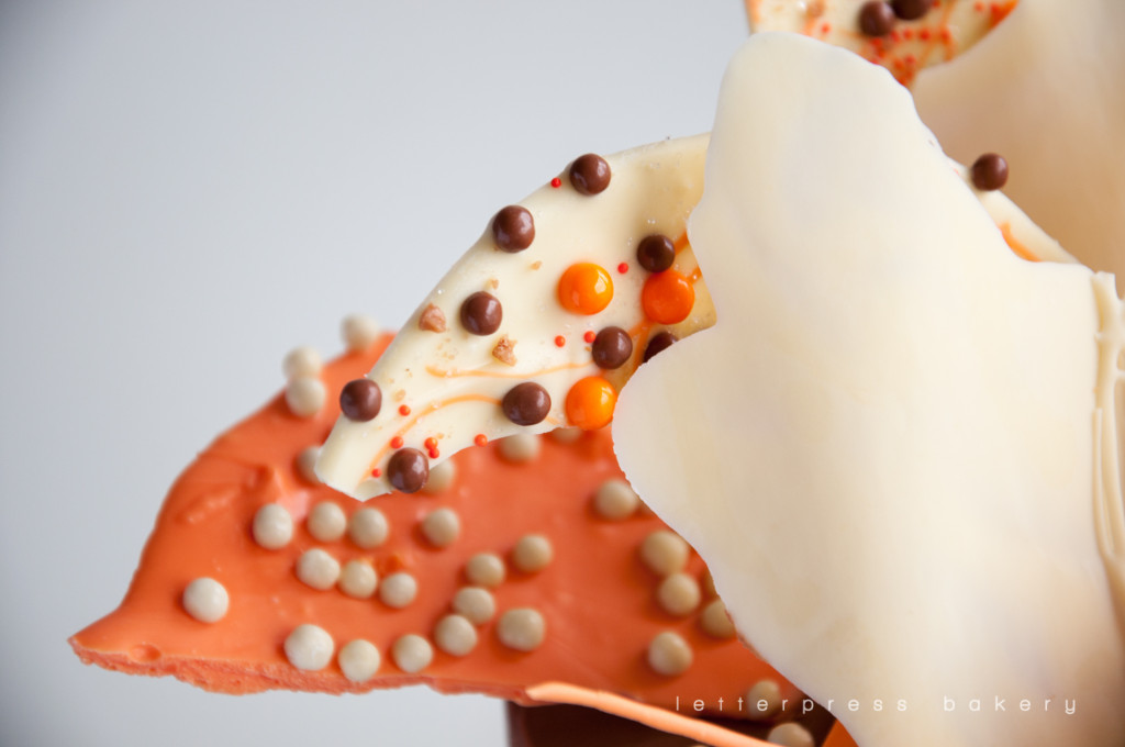 Chocolate crisp pearl decorated white and orange chocolate shards